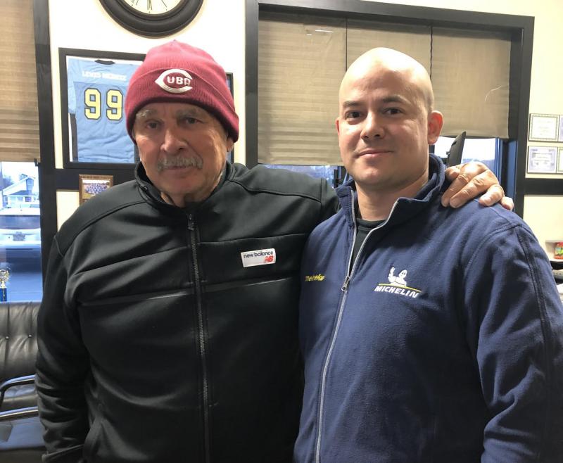 Fredman and Orlando Herrera at Meineke discussing baseball, geo-political history, languages and tire pressure. PHOTO BY ANGIE